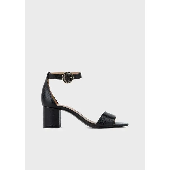 Leather sandals with heel and logoed medal